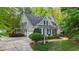 Beautiful home with a well-manicured lawn, lush greenery, and a welcoming front porch with decorative columns at 144 W Walker Woods Ln, Clayton, NC 27527