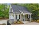 Exterior view showcasing a two-car garage with painted siding and black window shutters at 144 W Walker Woods Ln, Clayton, NC 27527