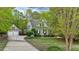 Charming home with a detached garage, a well-manicured lawn, and mature trees surrounding the property at 144 W Walker Woods Ln, Clayton, NC 27527