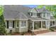 Rear exterior view featuring covered porch, brick steps, and neutral painted siding at 144 W Walker Woods Ln, Clayton, NC 27527