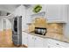 Elegant kitchen with stainless steel appliances, granite countertops, and a decorative wreath above the range at 144 W Walker Woods Ln, Clayton, NC 27527