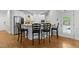 Kitchen island with granite countertop, bar stools, and stainless steel appliances at 144 W Walker Woods Ln, Clayton, NC 27527