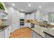 Modern kitchen with stainless steel appliances, granite countertops, and ample cabinet space at 144 W Walker Woods Ln, Clayton, NC 27527