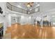 Open-concept living room with hardwood floors, fireplace, and staircase to the second floor at 144 W Walker Woods Ln, Clayton, NC 27527