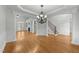Open-concept living room featuring hardwood floors, a fireplace, and architectural columns at 144 W Walker Woods Ln, Clayton, NC 27527