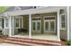 Covered patio with a swing, brick steps, and neutral painted siding at 144 W Walker Woods Ln, Clayton, NC 27527