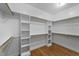 Large walk-in closet with hardwood floor and custom shelving at 144 W Walker Woods Ln, Clayton, NC 27527