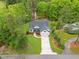 Aerial view of a well-maintained home with manicured lawns and mature trees, creating a private and peaceful setting at 1506 Gormly Cir, Sanford, NC 27330