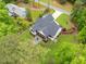 Aerial view showcasing the home's backyard with a patio, landscaping, and surrounding greenery, perfect for outdoor living at 1506 Gormly Cir, Sanford, NC 27330