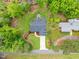An aerial view of a well-manicured home with a long driveway, lovely landscaping, and a gray roof at 1506 Gormly Cir, Sanford, NC 27330