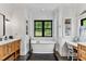 Bright bathroom with shiplap walls, a soaking tub, and wood vanity at 1506 Gormly Cir, Sanford, NC 27330