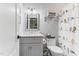 Gray bathroom featuring a granite countertop and a decorative shower curtain at 1506 Gormly Cir, Sanford, NC 27330