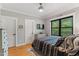 Light-filled bedroom featuring a black bedspread and dresser, and a window at 1506 Gormly Cir, Sanford, NC 27330