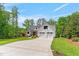 Charming two-story farmhouse with mature trees, landscaped lawn and a three-car garage at 1506 Gormly Cir, Sanford, NC 27330
