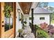 Charming front porch featuring a decorative door, potted plants, and an inviting seating area, perfect for relaxing at 1506 Gormly Cir, Sanford, NC 27330