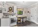 Laundry room with front loading washer and dryer, work table, and decor at 1506 Gormly Cir, Sanford, NC 27330