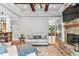 Bright living room featuring a stone fireplace, wood floors, and a view into the entry way, creating an inviting space at 1506 Gormly Cir, Sanford, NC 27330
