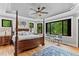 Spacious main bedroom boasts a tray ceiling, ceiling fan, and natural light at 1506 Gormly Cir, Sanford, NC 27330