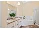 Bathroom featuring double sinks, soaking tub and standing shower at 1601 Entheos Ln, Raleigh, NC 27610