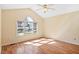 Sunlit bedroom with vaulted ceiling, ceiling fan, and large window at 1601 Entheos Ln, Raleigh, NC 27610