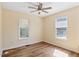 Bright bedroom features hardwood floors and a modern ceiling fan at 1601 Entheos Ln, Raleigh, NC 27610