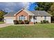 Charming home featuring a manicured lawn, brick accents, and inviting curb appeal at 1601 Entheos Ln, Raleigh, NC 27610