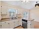 Bright kitchen showcasing stainless steel dishwasher, double sink, and a window with natural light at 1601 Entheos Ln, Raleigh, NC 27610