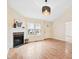 Cozy living room with vaulted ceiling, fireplace, and hardwood floors at 1601 Entheos Ln, Raleigh, NC 27610