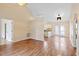 Open-concept living area with hardwood floors, and access to the kitchen and outdoor space at 1601 Entheos Ln, Raleigh, NC 27610