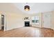 Bright living room with fireplace, hardwood floors, and large windows at 1601 Entheos Ln, Raleigh, NC 27610