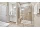 Bathroom featuring a glass-enclosed shower with a built-in seat, and vanity with mirror and white cabinets at 1614 Brussels Drive Dr, Apex, NC 27502