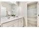 Bright bathroom featuring a double vanity, large mirror, and a separate shower/tub area at 1614 Brussels Drive Dr, Apex, NC 27502