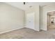 Bedroom with carpet and ceiling fan showing a closet and an attached hallway with doorway at 1614 Brussels Drive Dr, Apex, NC 27502