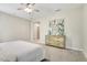 Bedroom featuring a dresser with decorative vases and artwork, as well as an attached hallway and doorway at 1614 Brussels Drive Dr, Apex, NC 27502