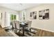 Dining space with sleek table and chairs, complemented by natural light at 1614 Brussels Drive Dr, Apex, NC 27502