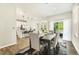 Dining area with a modern table, chairs, and view of kitchen and sliding glass door at 1614 Brussels Drive Dr, Apex, NC 27502