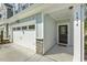 Townhouse entrance with a garage, number 1614 and a welcome mat at 1614 Brussels Drive Dr, Apex, NC 27502