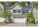 Townhouse showcasing a two-car garage, neutral siding and a well-manicured front yard at 1614 Brussels Drive Dr, Apex, NC 27502