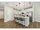 Bright kitchen featuring white cabinets, stainless steel appliances, and an island with bar seating at 1614 Brussels Drive Dr, Apex, NC 27502