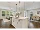 Open kitchen with a center island, stainless appliances, and seamless flow to the dining area at 1614 Brussels Drive Dr, Apex, NC 27502