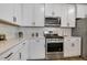 Bright kitchen with white cabinets, stainless steel appliances, and a subway tile backsplash at 1614 Brussels Drive Dr, Apex, NC 27502