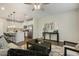 Open-concept kitchen with white cabinets, stainless steel appliances, and seamless flow to the living area at 1614 Brussels Drive Dr, Apex, NC 27502
