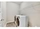 Practical laundry room with modern, front-loading washer and dryer, plus a convenient storage shelf at 1614 Brussels Drive Dr, Apex, NC 27502