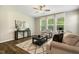 Inviting living room featuring a modern ceiling fan, neutral colors and lots of natural light at 1614 Brussels Drive Dr, Apex, NC 27502