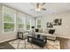 Bright living room with large windows, modern furnishings, and stylish decor at 1614 Brussels Drive Dr, Apex, NC 27502