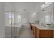 Bathroom featuring double sinks with wood cabinets and a separate tub and shower at 1640 Legendary Ln, Morrisville, NC 27560