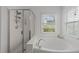 Bright bathroom with a soaking tub and separate glass-enclosed shower with nice finishes at 1640 Legendary Ln, Morrisville, NC 27560