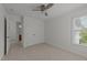 Neutral bedroom featuring plush carpet, a modern ceiling fan, bright windows, and a closet at 1640 Legendary Ln, Morrisville, NC 27560
