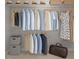 Organized closet features hanging clothes, storage bins, hats, and a duffel bag at 1640 Legendary Ln, Morrisville, NC 27560