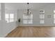 Bright dining room area with hardwood floors and classic chandelier, perfect for dinner gatherings at 1640 Legendary Ln, Morrisville, NC 27560